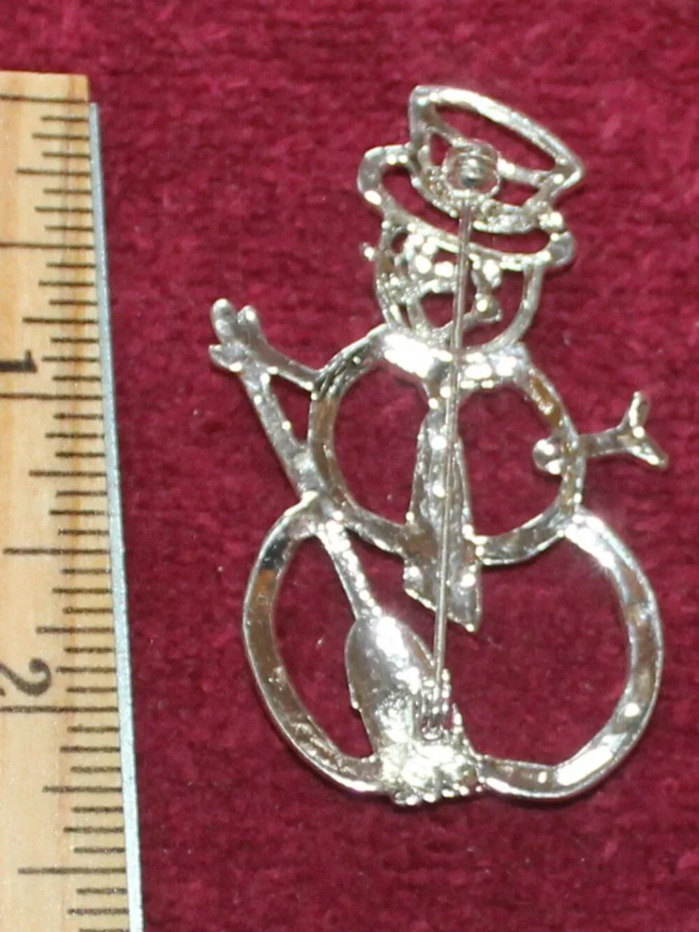 Vintage figural snowman brooch designed with a silver-tone metal color accents